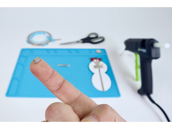 Roll one of those pieces into a tape loop as shown.