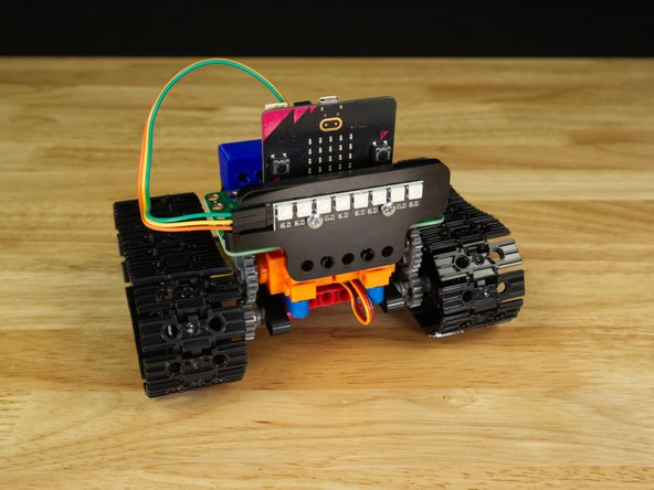 If you have a Bit Board Rover your Addressable RGB LED Strip came attached to a piece of acrylic. This allows it to attach to the front of the Rover using two black pins.