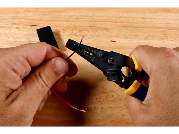 Use a wire strippers to strip away another 1/4&quot;-1/2&quot; of insulation from each of the two wires that lead from the body of the battery pack.