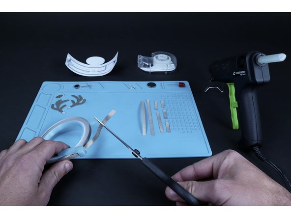 Use the circuit diagram on the back of the project to help you measure and cut the number of  pieces of conductive Maker Tape required for the project you chose. Rudolph will require 8 total pieces while Santa will require only 5 (this includes 1 piece for a tape loop).