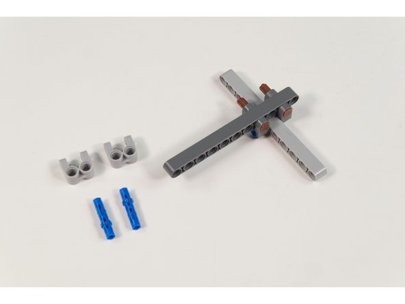 Place 2 LEGO Long Pin with Friction into LEGO Beam 11 (32525 / 64290)  as shown.