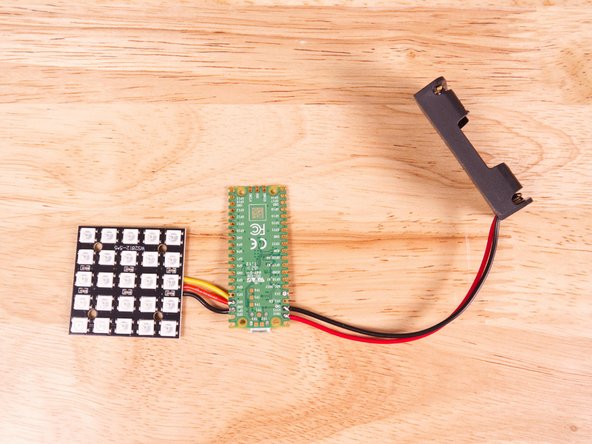 Solder the black wire to the GND pin hole right next to VSYS. The GND pin hole is the third from the end.