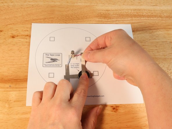 Using Maker Tape add Tape Path E. to the top of the battery and onto the template.