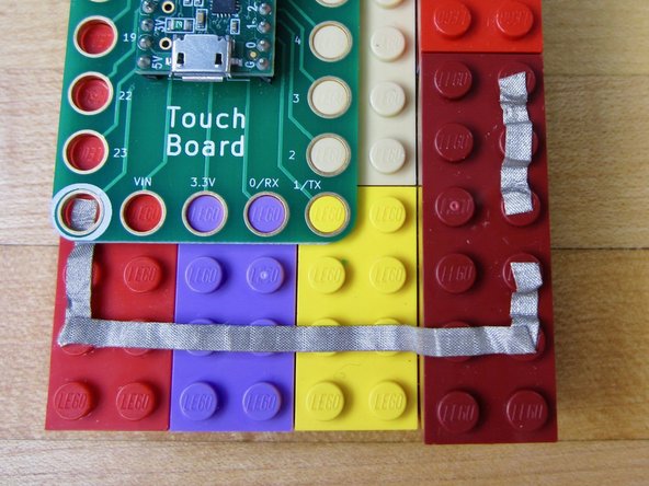 Use several small pieces of Maker Tape to connect the Grounds on each LED.