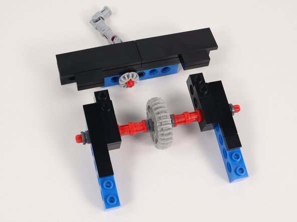 Connect Section 1 and Section 2 by lining up the gears so they interlock and the two open studs on Section 2 snap in place to the bottom side of Section 1.