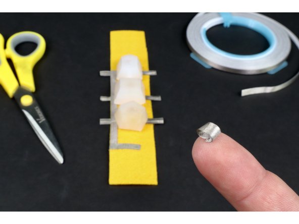 Snip another small piece of Maker Tape and roll it into a tape loop as shown in photo 1.