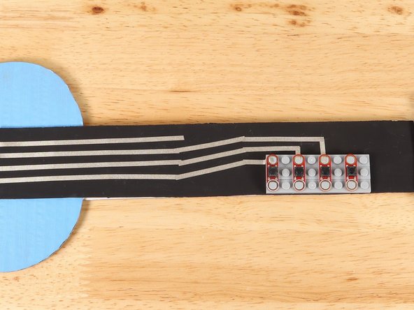 Add a piece of Maker Tape perpendicular to the first path that begins to lead down the neck.