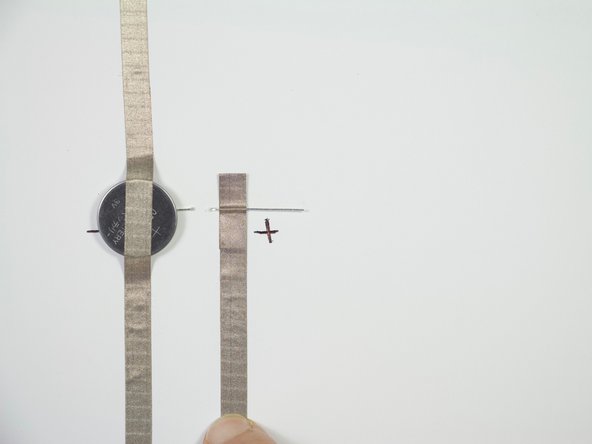 Adhere Maker Tape to the positive side of the LED, then continue to connect this piece with the piece of Maker Tape coming from the other side of the switch.