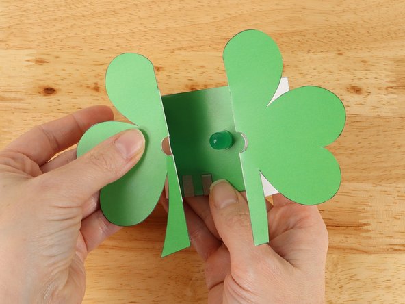 The two innermost dotted lines should be folded with a valley fold. When done correctly, the two halves of the shamrock will line up with each other around the LED.