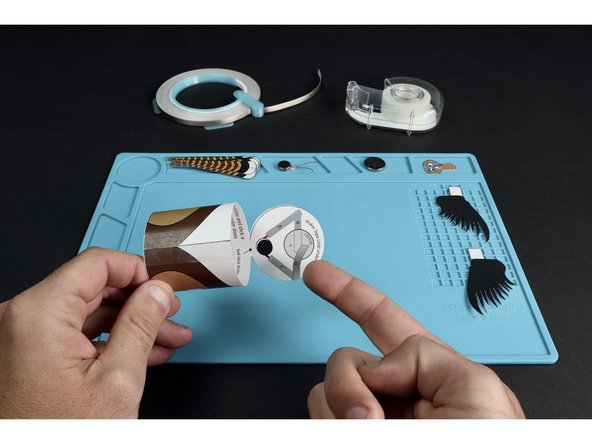Use the circuit diagram on the back of the project's circular lid to assemble the circuit.