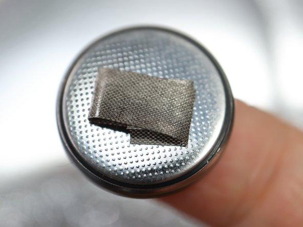 To add the battery using only Maker Tape, first put a small loop of tape on the negative side as shown.