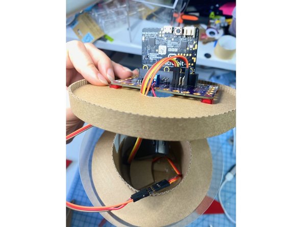 We threaded the wires from the distance sensor and the servo motor through the center tube and up through the hole in the top.