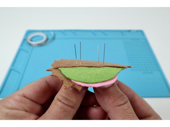 Thread the two legs of the remaining LED through the remaining pairs of holes using the same orientation of short and long legs you chose for the first one.