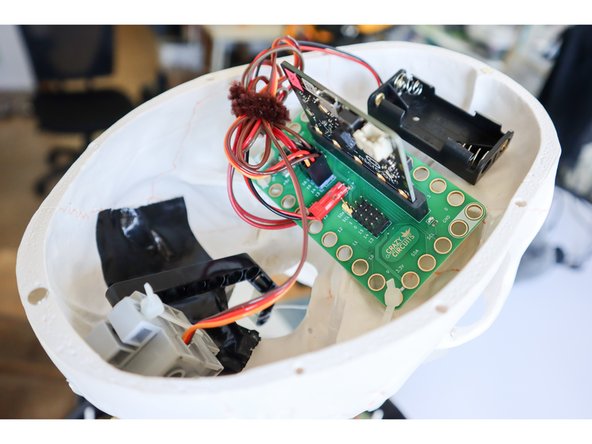 Drill holes in the skull to attach the components as shown: