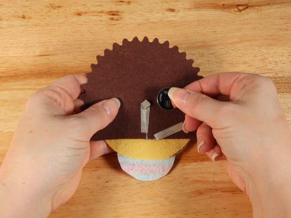 Make sure the Positive side of the Battery is facing upwards, with the Negative side stuck down to the tape.