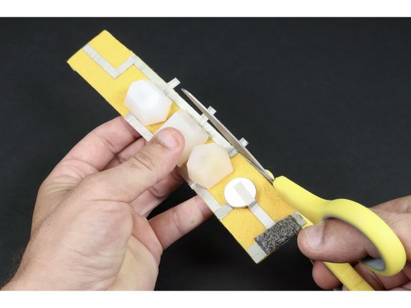 Use your scissors to trim the parts of the LED legs that hang off the edge of the bracelet.