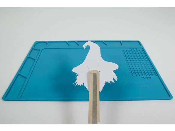 Fold the outer (short) LED legs down flat against the upward-facing side of the wand handle in a slight &quot;V&quot;.