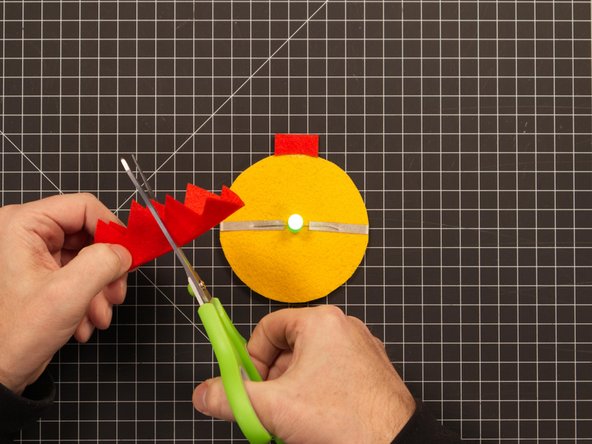 You can easily cut a slit by folding over the decoration and making a small cut. (Start small, and try to fit it over the LED. If you need to make the slit longer, cut a little more.)