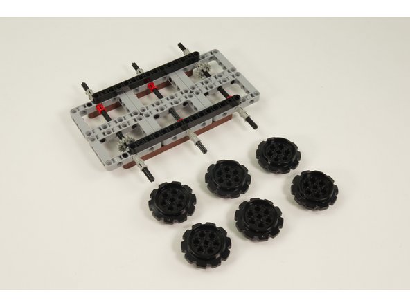 Slide the 6 LEGO Technic Sprocket Wheel 40.4 parts onto the axles.