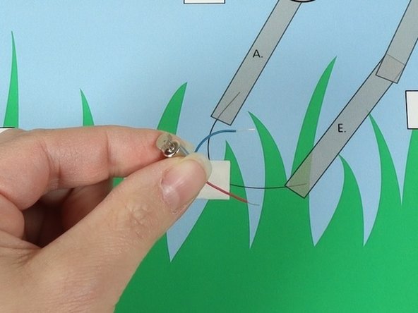 Stick the motor to the double sided tape making sure the back of the motor (with the wires) is stuck down to the tape and the part that spins faces upwards so it can move freely.