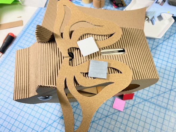 We tested our acrylic paints on cardboard squares to choose colors. (Sometimes paint shows up differently when you paint it on the brown cardboard color.)