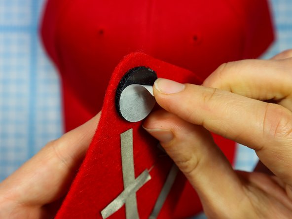 Then, peel the paper backing off of the other side and stick the design to the hat.