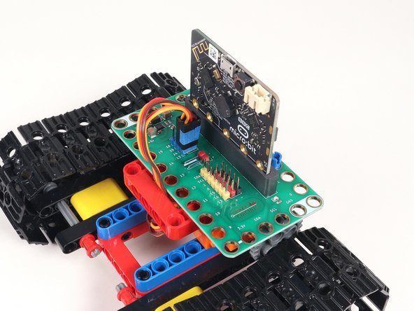 Plug the right servo into the row for Pin 14, matching the orientation of the servo connector for the left servo.