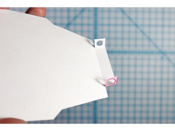 Fold the template on the dotted lines, with the holes facing each other as shown.