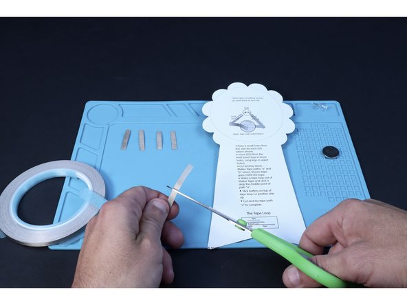 Use the circuit diagram and a scissors to help you measure and cut four small pieces of Maker Tape.