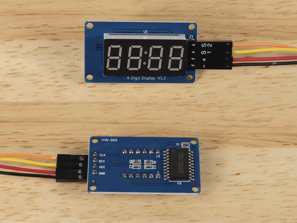 The 7 Segment Display has four pins. We'll connect the - wire to GND, the + wire to VCC, the S1 wire to DIO and the S2 wire to CLK.