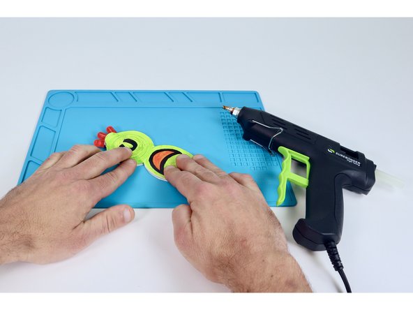Press your colored top atop this glue bead so it lines up with the bottom shape and hides the battery.