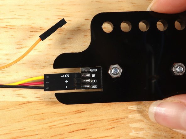 So let's get connected! If you turn the NeoPixel Strip over you'll see labels for the three pins. You should see IN, VCC, and GND.