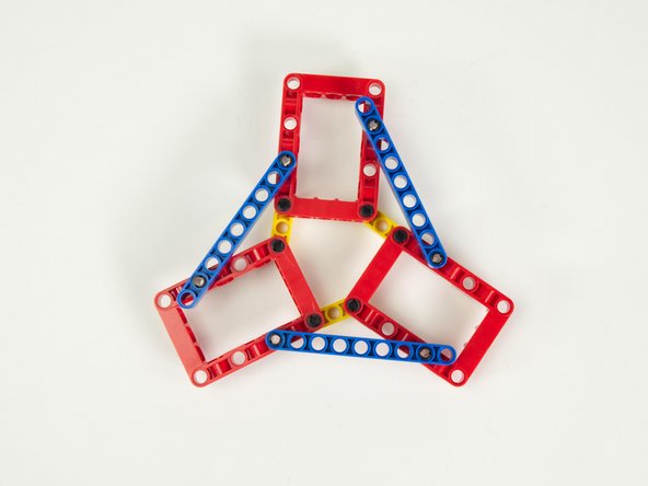 ...and the pin in the opposite side of the blue beam goes into the second hole in the red frame closest to the outside of the frame.