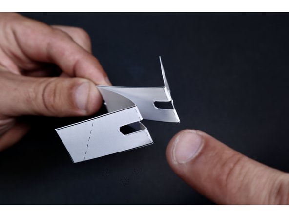 Fold the next set of dotted lines that are printed across the two outer slots in the opposite direction as the first fold (as shown).