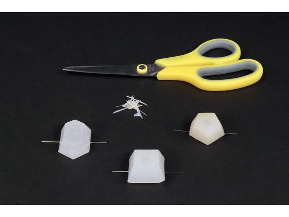 Notice that, for each LED, there is a short leg and a longer leg. Bend the legs of each outward in opposite directions and note which are the short and which are the long. You will need to orient the LED jewels on the felt with all short legs on one side and all long legs on the opposite side.