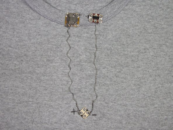 Continue to make connections with the conductive thread as shown. Be sure to start and finish each stitch with a few finishing knots around each of the circuit board holes.