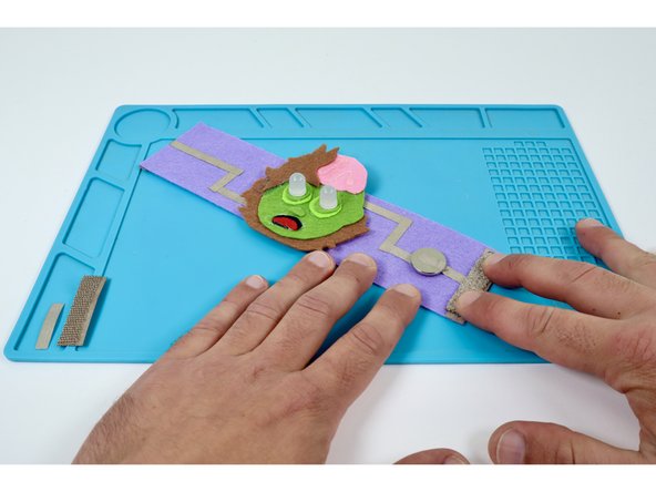 Press one half of your conductive hook and loop atop the edge pad.