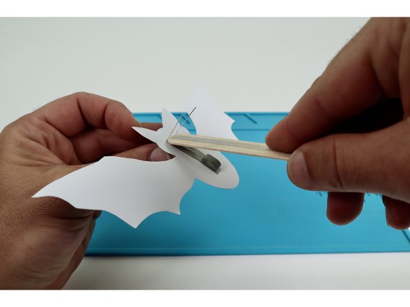 Seat one end of the wand handle between the two outer LED legs and press into place so that the Maker Tape Loop contacts the downward-facing path of the wand handle.