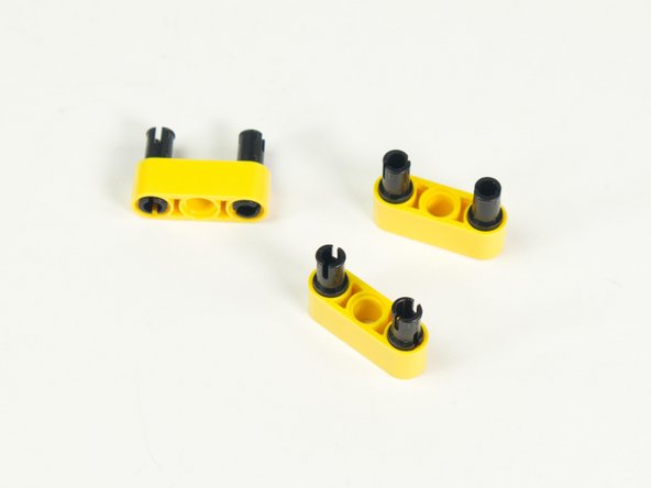 Add two black pins to each yellow beam, on the ends, leaving the middle holes empty.