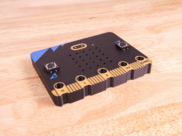 Insert the legs of the buttons through the slots for the A and B buttons on the 3D Printed Micro:Bit.