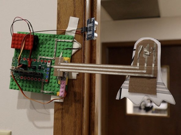 We attached our ghost mechanism to a wooden door frame with some low-tack tape.