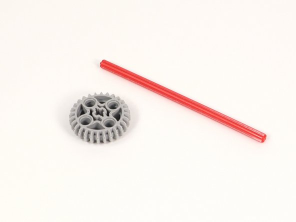 Add the large gear to the center of the 12-stud long axle.