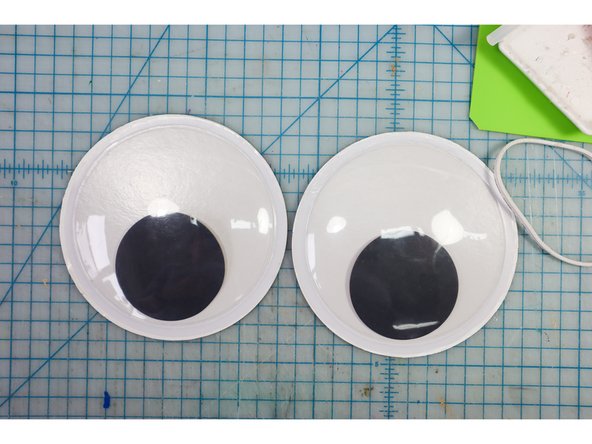Use a box cutter to carefully remove the plastic from the back of the googly eyes.