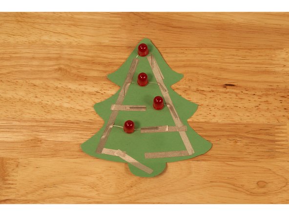 Use a piece of Maker Tape to secure down each of the legs.