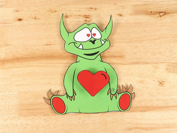 Add hot glue or  another square of double-sided tape onto the middle of the heart template, and then stick the heart to the top of the motor.