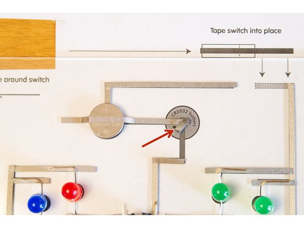 Since the tape is conductive all the way through, we can make tape loops to hold the batteries down and serve as a conductor that connects the battery to the &quot;trace&quot; on the board.