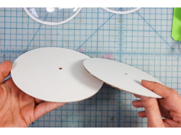 Glue the white cardstock circles to the cardboard circles with a glue stick.