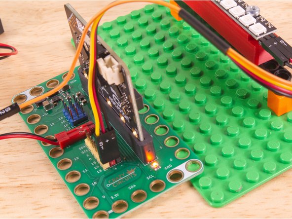 Use the Crazy Circuits Ribbon Cable to connect the NeoPixel Strip to the Bit Board.
