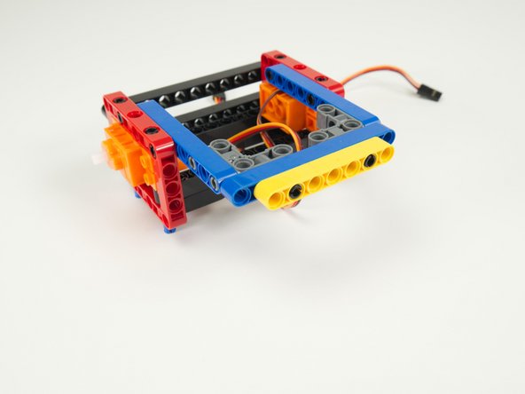 After adding the black pins you can attach the final rear yellow beam.