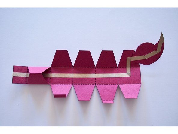 Fold and glue the first section of the tail to make a triangular shape as shown.